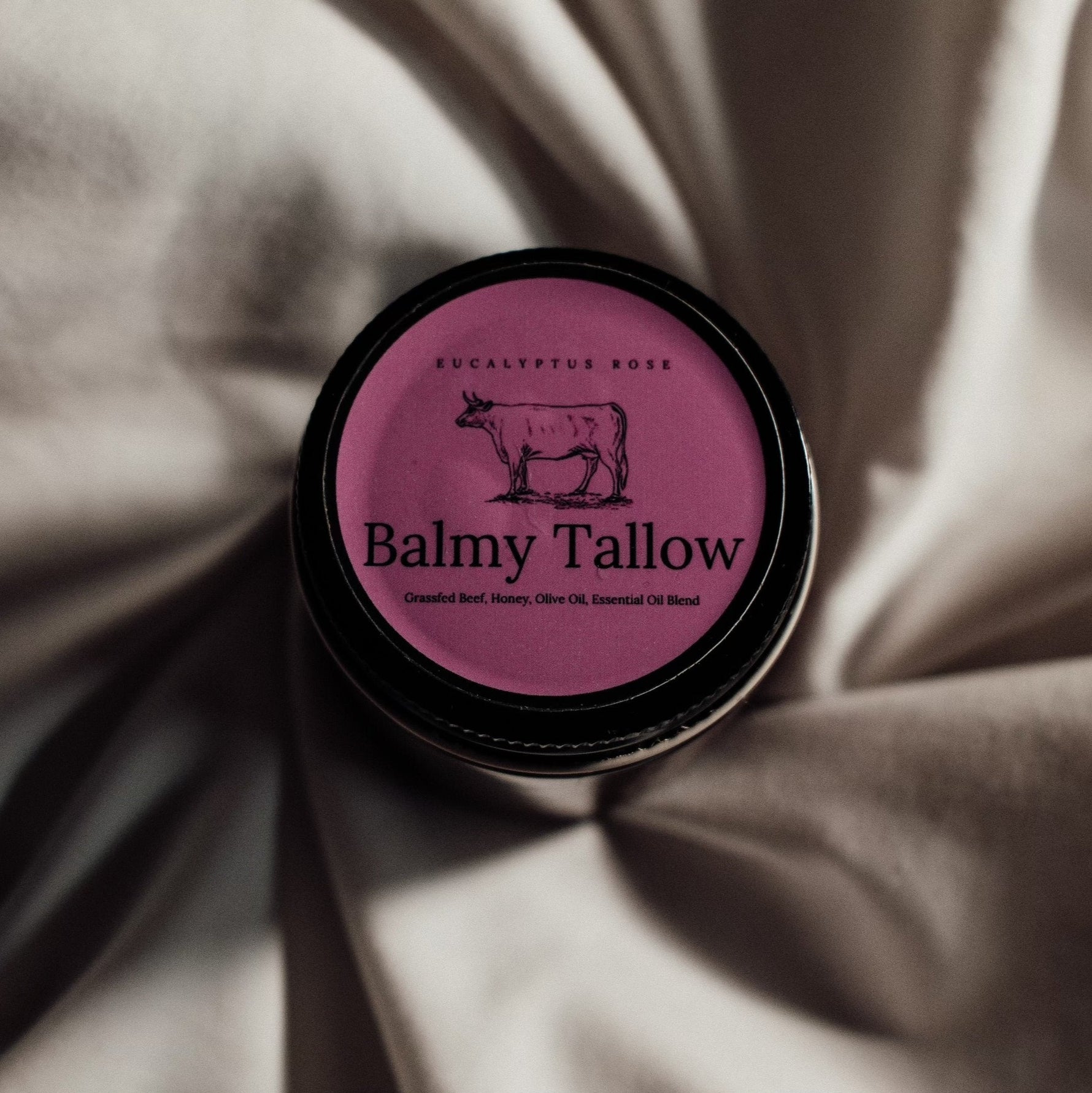 Eucalyptus Rose grassfed beef tallow balm by Balmy Tallow, pink label with cow illustration