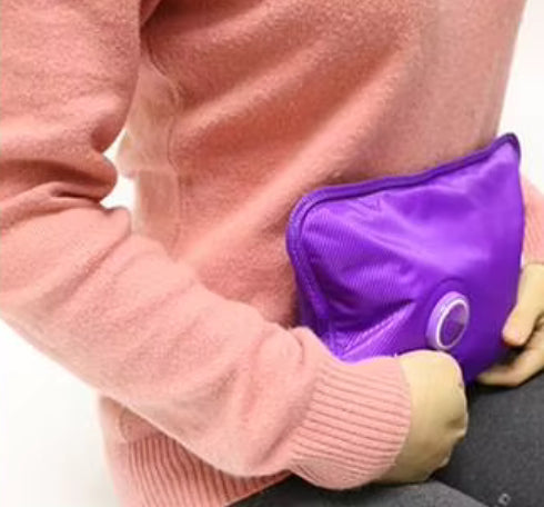 Electric hot water bottle being held