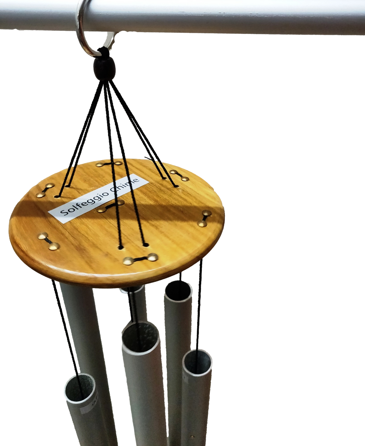 Solfeggio wind chime hanging outdoors in a garden