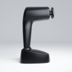 NOVAFON max+ sound wave device with disc attachment, shown from the side in its charging station