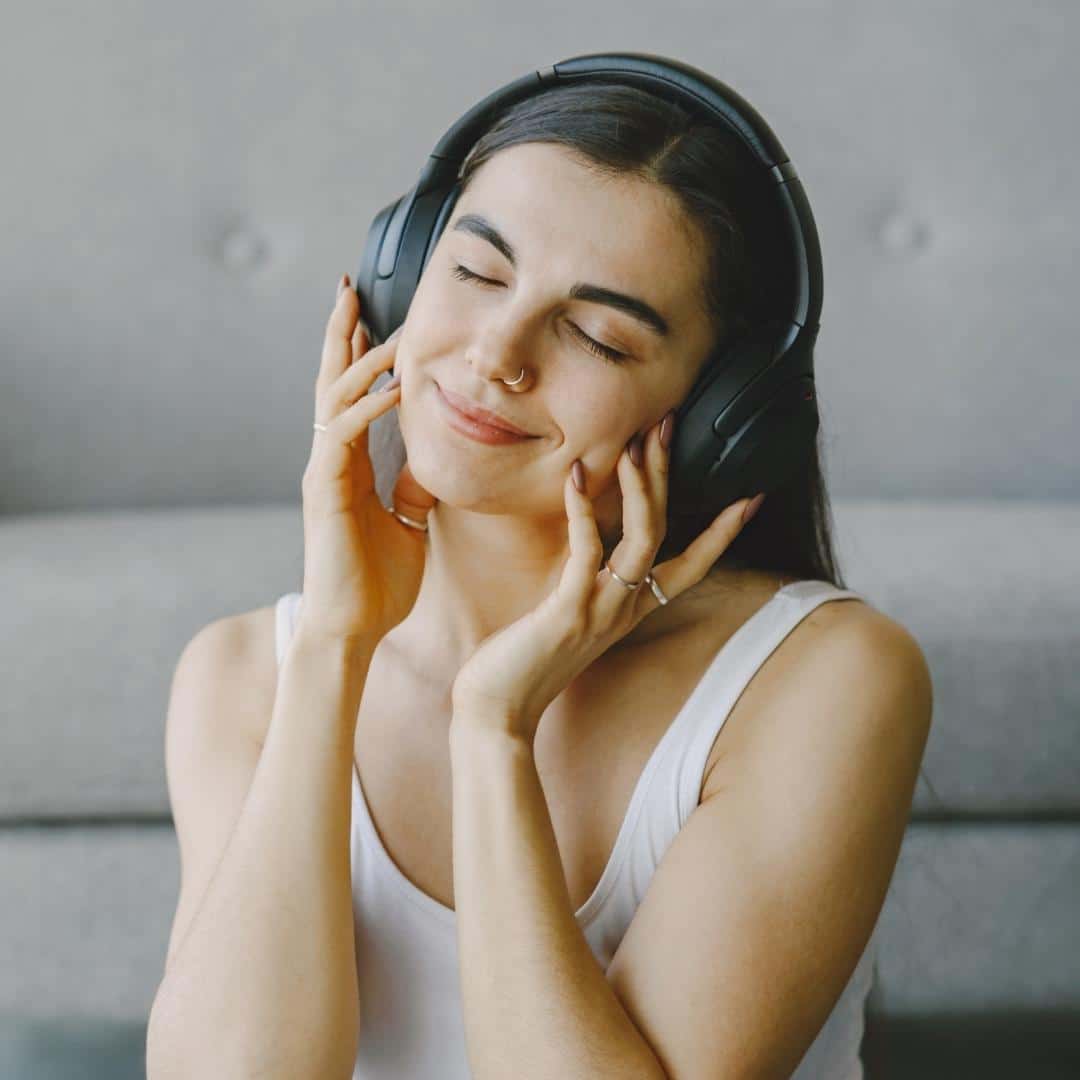 Happy woman listening to headphones