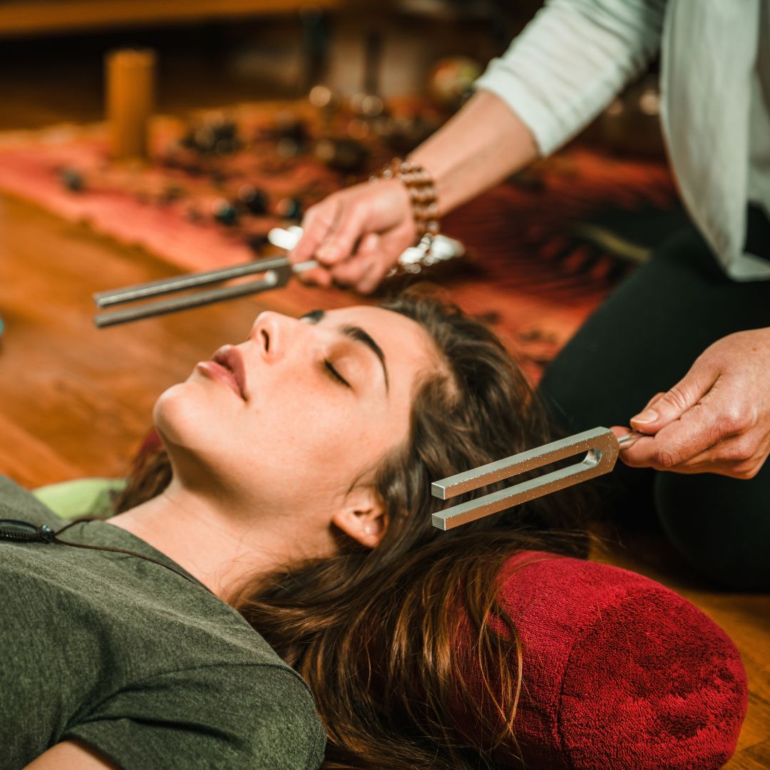 woman receiving tuning fork therapy